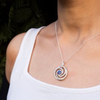 Swirl Diamond Halo Pendant With 6mm Tanzanite Prong Set In 14k White Gold Spiral Pendants