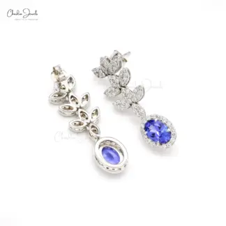 Oval tanzanite dangle earrings with halo design